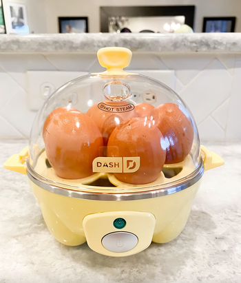 A close-up view of the vibrant yellow egg cooker