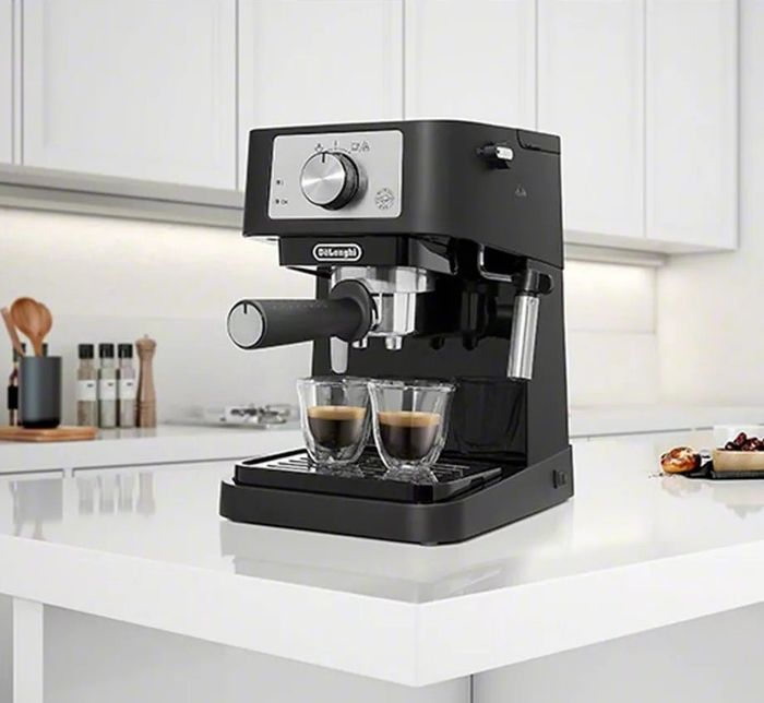 The espresso machine brewing a fresh shot of coffee.