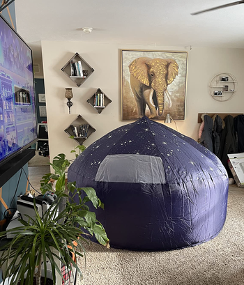 An inflatable fort set up in the reviewer's living room