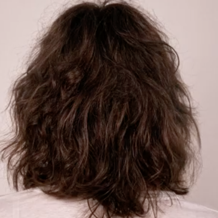 The model's hair is shown prior to using the product.