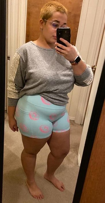 The reviewer is shown wearing the playful doughnut print shorts.
