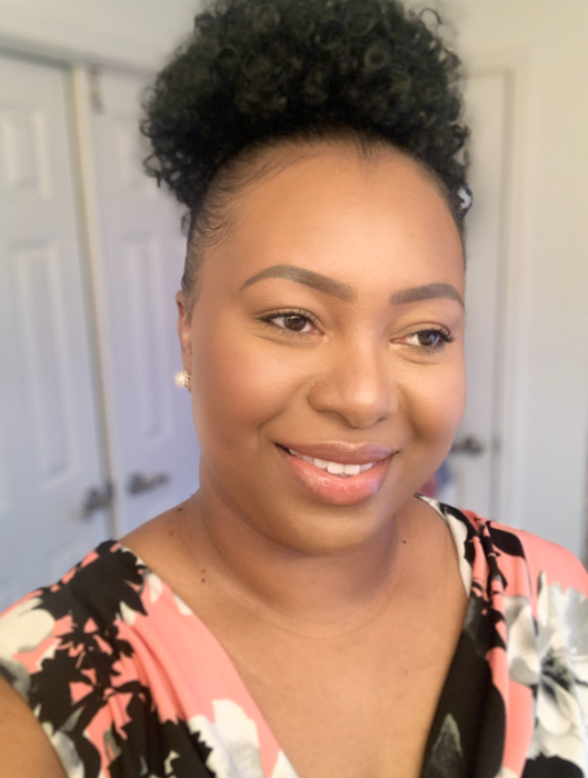 A reviewer with a puff clipped into their hair.