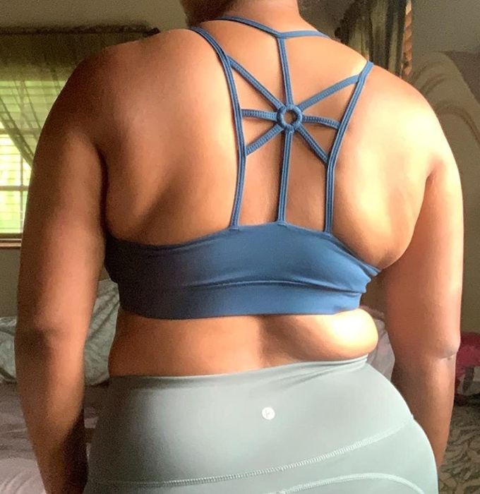 back view of reviewer wearing the blue bra to highlight the strap pattern