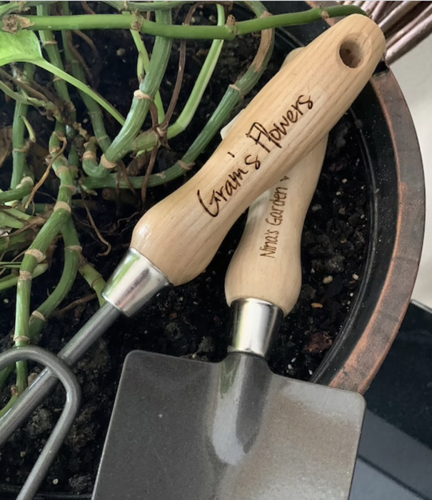 The tools are displayed with handles engraved with 'Gram's Flowers'.
