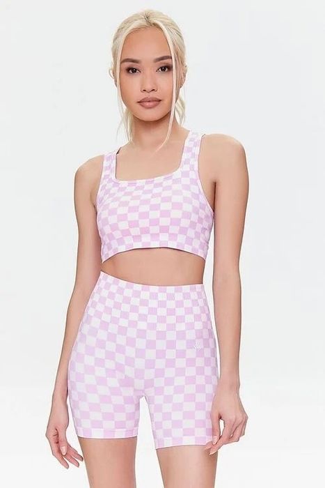 model wearing the matching pink and white checkered shorts and bra set