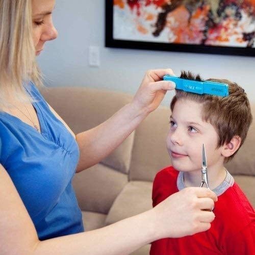 A parent using the CreaClip to trim their child's bangs.