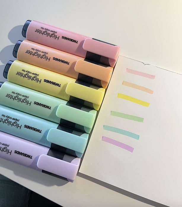 A vibrant array of pastel highlighter inks in shades of purple, blue, green, yellow, orange, and pink, beautifully swatched on paper.