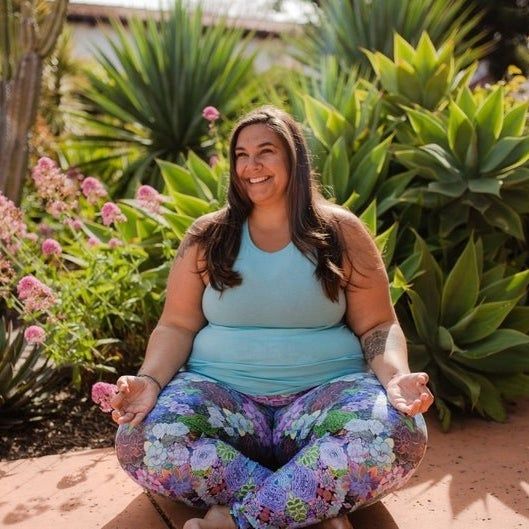 a model showcasing the succulent leggings while performing a yoga pose