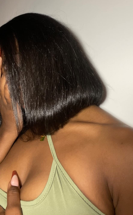 A reviewer showcasing a sleek bob blowout.
