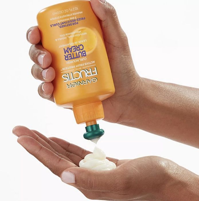 The cream being dispensed into someone's hands.