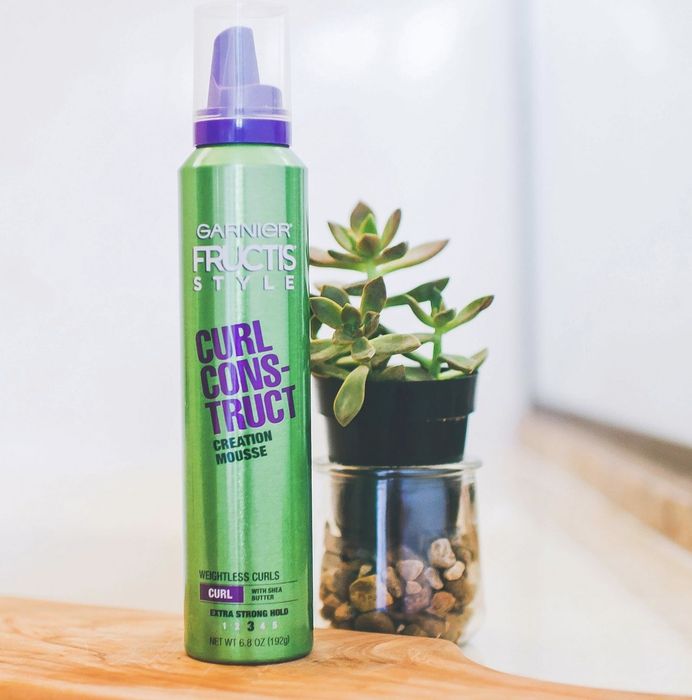 A green can of hair mousse