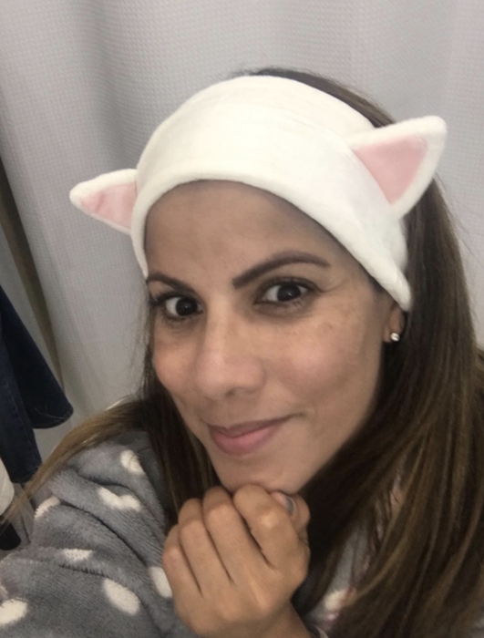 A customer is seen wearing a kitten ear headband.