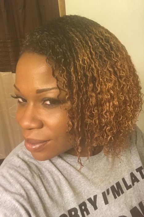 A Black reviewer with a 3c-4a hair texture demonstrates how the brush helps detangle the hair without disrupting the curl pattern.