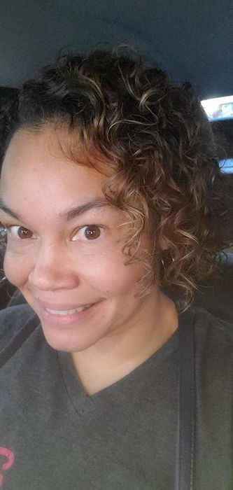 The reviewer’s hair after using the OGX air-dry cream, looking perfectly defined and frizz-free.