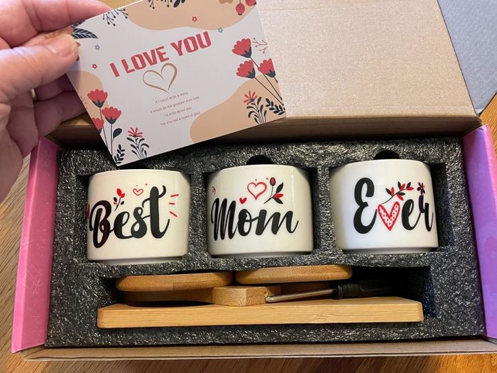 A gift box containing three mugs with the words 