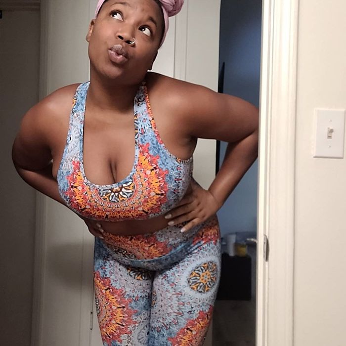 A reviewer displays a stunning blue and red floral print set, exuding a fresh and vibrant style.