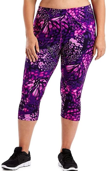 A model is wearing the pink and purple butterfly print leggings.