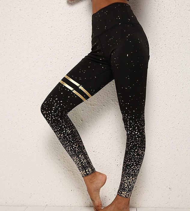 model wearing the black and gold leggings