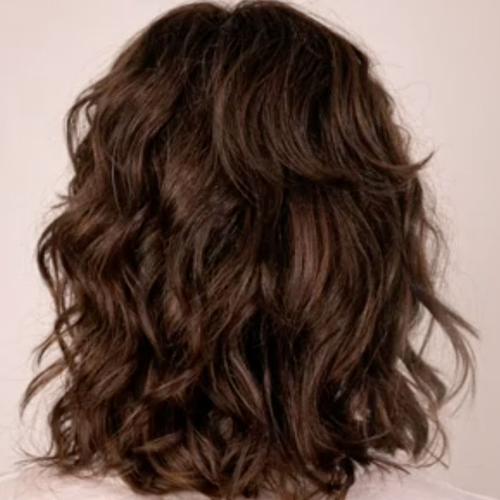 The model's hair is displayed after using the product, showcasing the results.