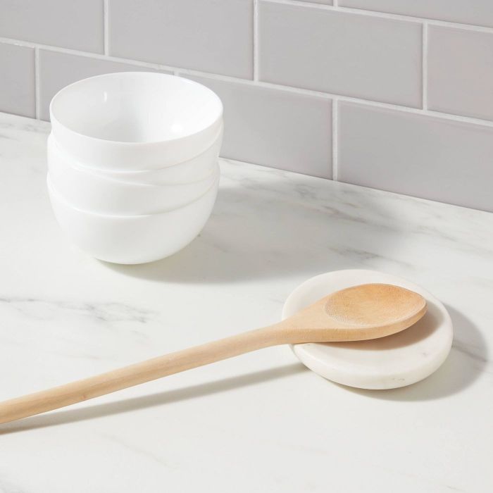 The spoon rest holding a wooden spoon