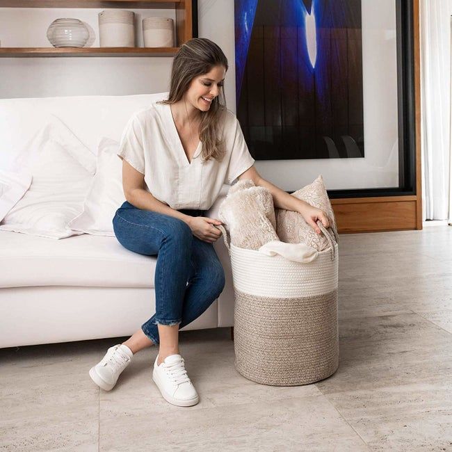 A two-toned beige and brown soft laundry hamper featuring sturdy handles