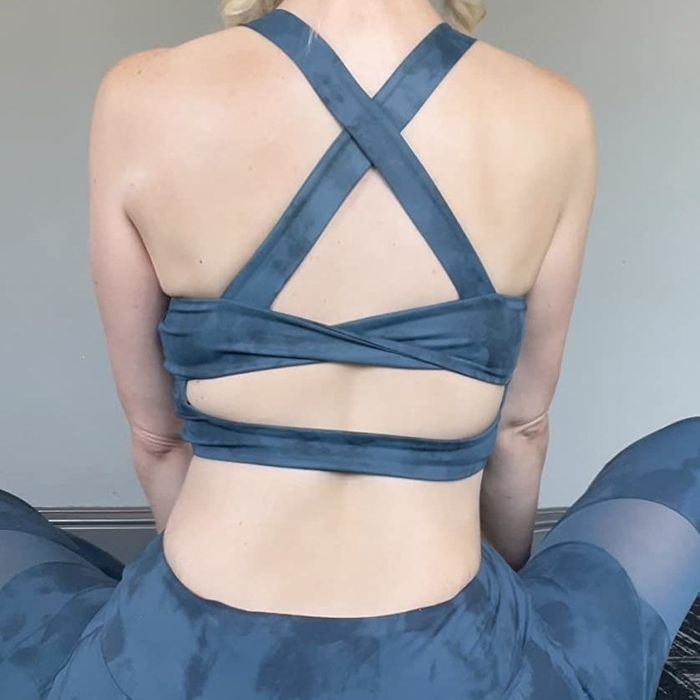 A shot from the back of the reviewer wearing the blue top, highlighting the crossed straps.
