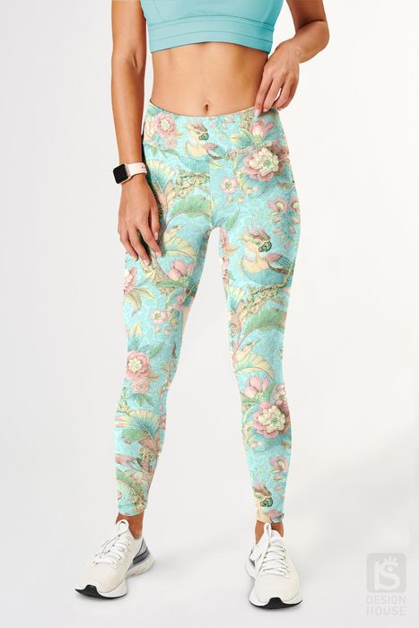 The model is shown from the front, showcasing teal leggings adorned with a parrot print.