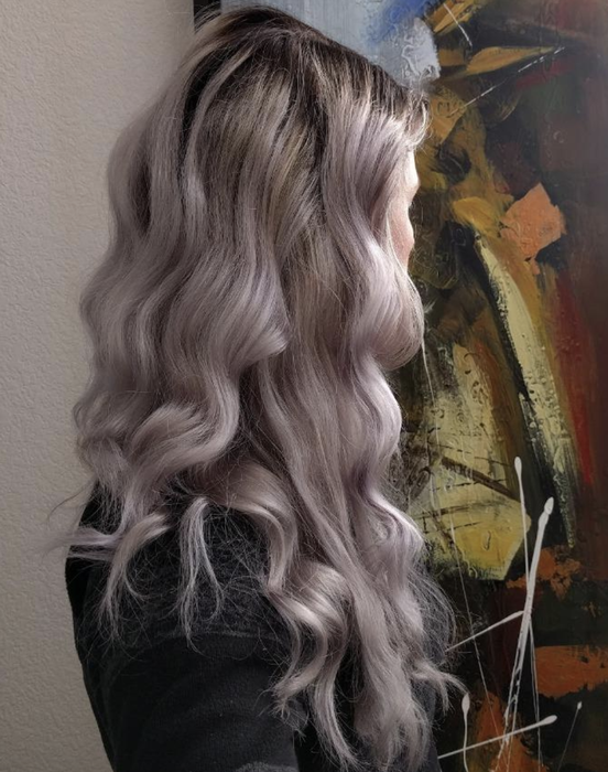 A reviewer's hair styled in curls
