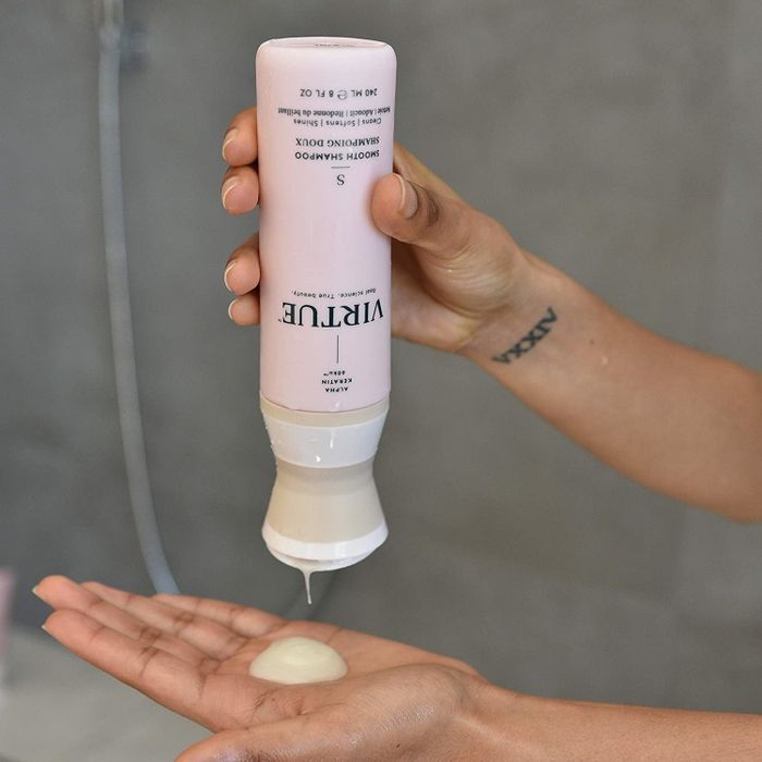 A model demonstrates the product by squeezing it from the bottle into their hands.