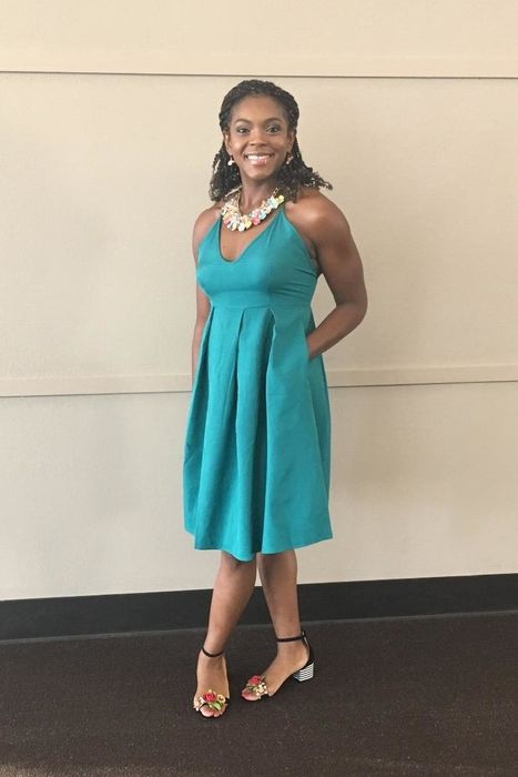 A reviewer modeling the dress in a striking blue shade.
