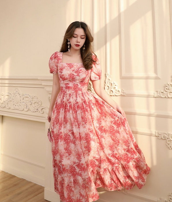 A model showcasing the puff sleeve square neck midi dress.