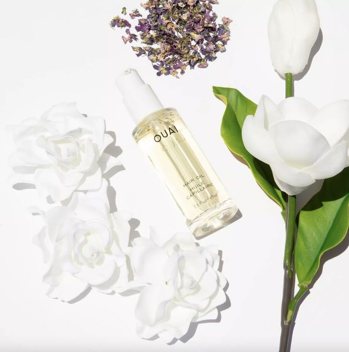 A bottle of hair oil and flowers