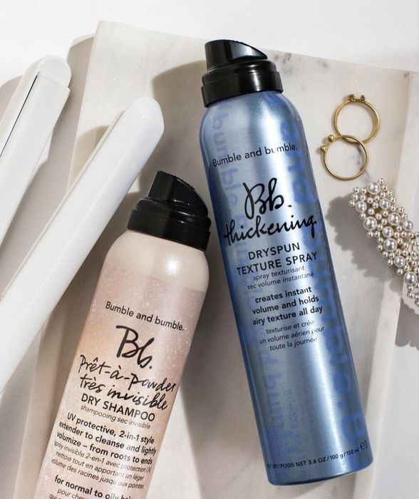 A can of dry shampoo and texture spray