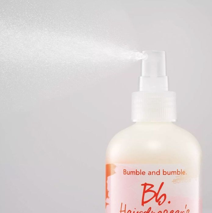 The bottle, featuring a white, pink, and orange design with the label 