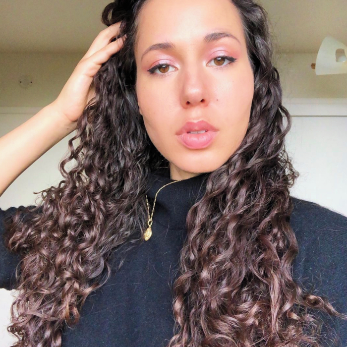 An individual showcasing their hair after using only shampoo, without any conditioner or additional styling products.