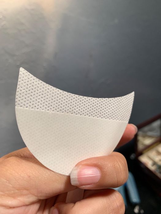 A reviewer showcases the eyeshadow patch in their hand.