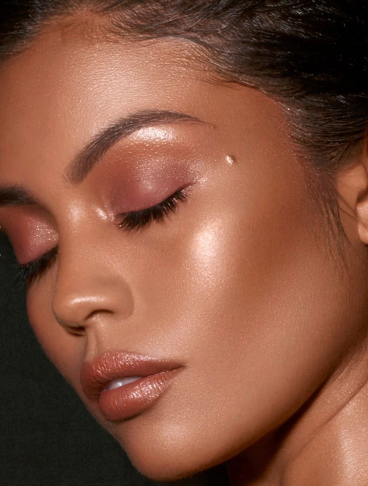 Model showcasing the pigments on their cheeks, lips, and eyes