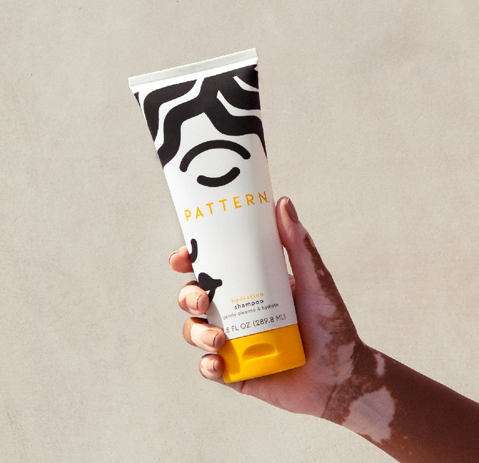 Model showcasing the shampoo bottle