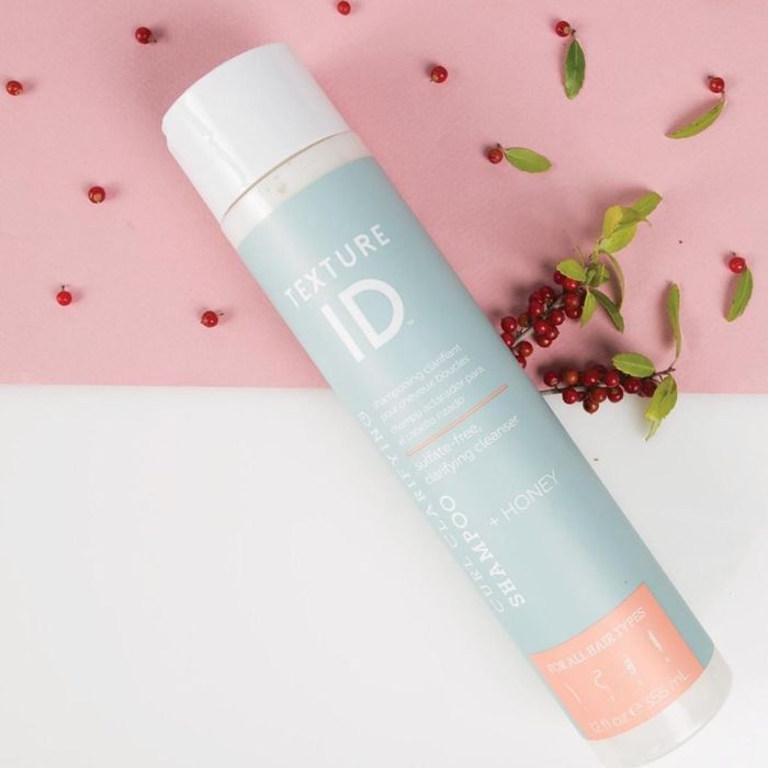 A bottle of shampoo designed to enhance hair texture and health.