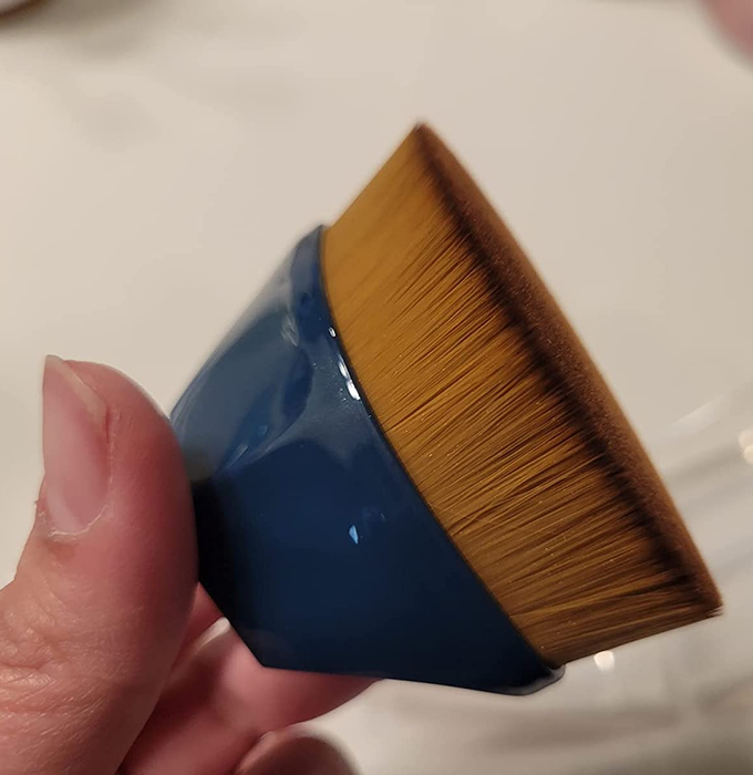 A side view of a reviewer's foundation brush