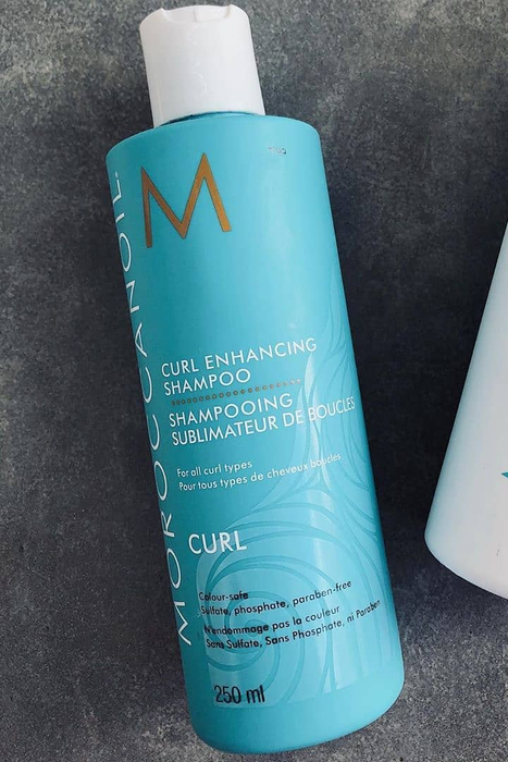 A blue bottle of Curl Enhancing Shampoo
