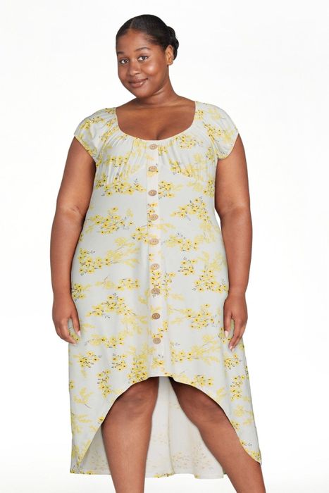 The model is dressed in the winter white dress, showcasing its timeless and chic aesthetic.
