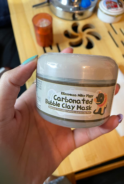 A reviewer holding the jar
