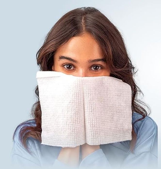 A model holding the Clean Skin Club towels