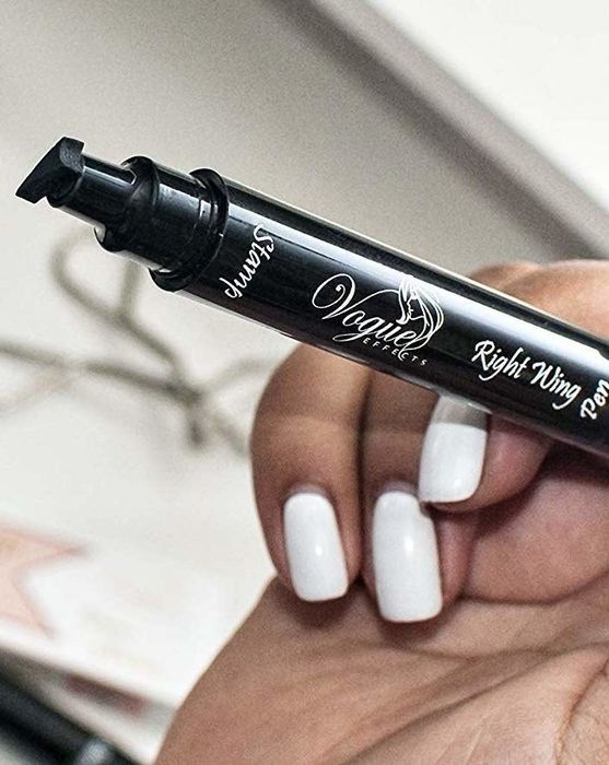 a model holding the black pen featuring a slanted eyeliner stamp at the tip