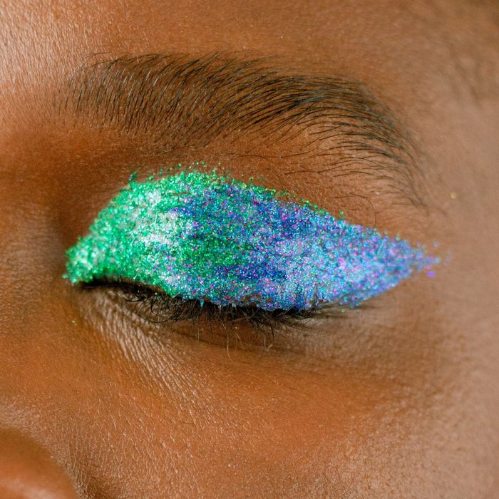 model displaying a vibrant green and blue eye look created with the eyeliners
