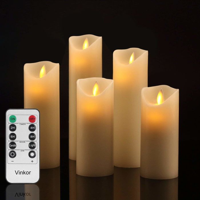 The set includes five candles of varying heights and a remote control