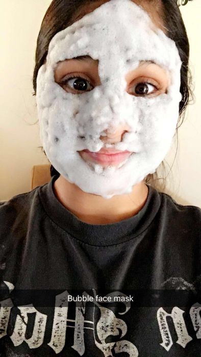 A reviewer sporting the bubble-filled face mask