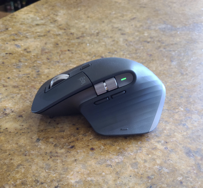 The ergonomic mouse, designed to enhance comfort during long hours of work.