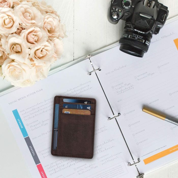The same sleek wallet positioned next to the camera on the agenda.